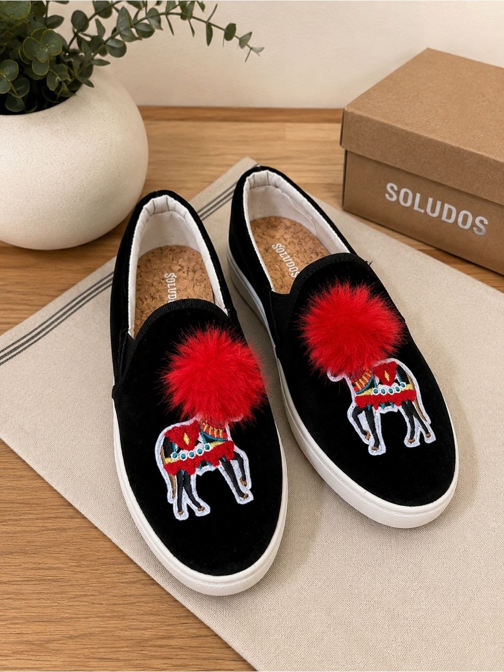 Soludos Black Velvet Slip-Ons with Red Pom Pom and Embroidered Camel